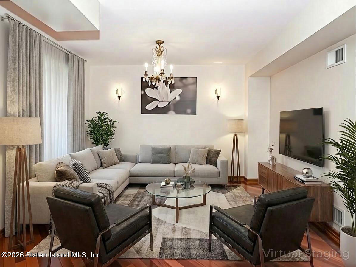 45 Fairlawn Loop Staten Island, NY 10308 - Photo 8 of 49 a living room with furniture and a flat screen tv