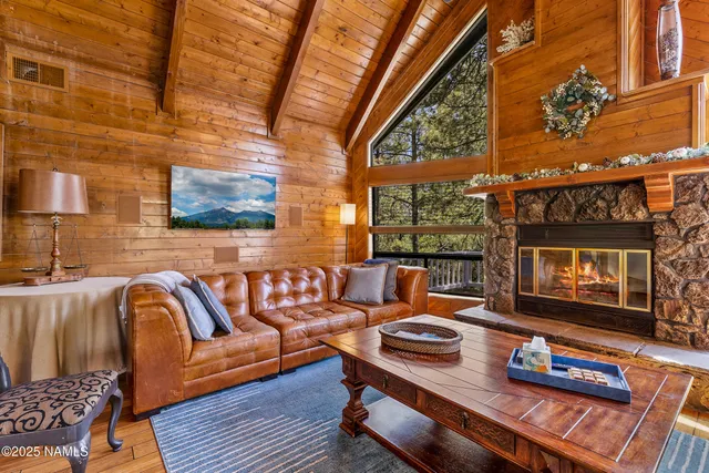 a living room with furniture fireplace and flat screen tv