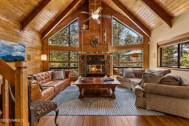 a living room with furniture a fireplace and a large window