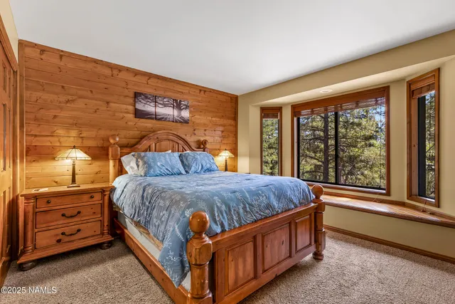 a bed sitting in a bedroom next to a window