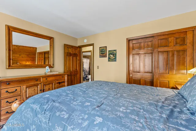 a bedroom with a bed and a dresser