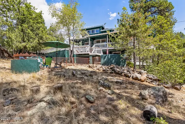 a view of a house with a yard and sitting area