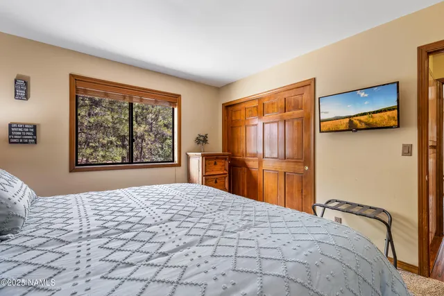 a bedroom with a large bed and a window