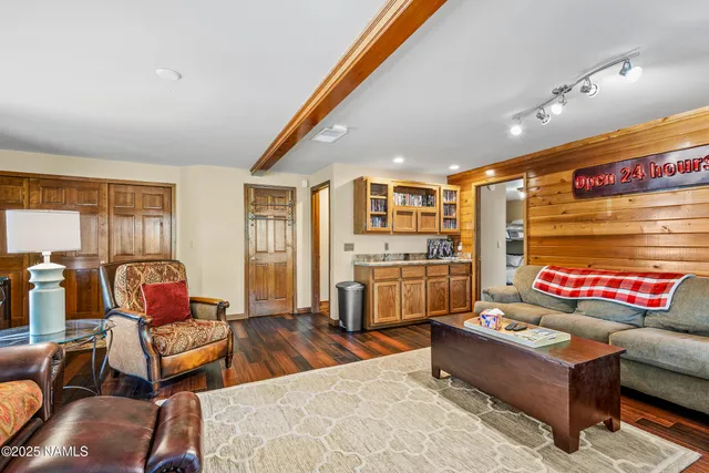 a living room with furniture and a floor to ceiling window