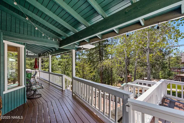 a view of balcony with wooden floor and fence