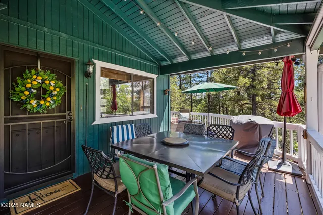 a view of a patio with a table chairs and a wooden deck