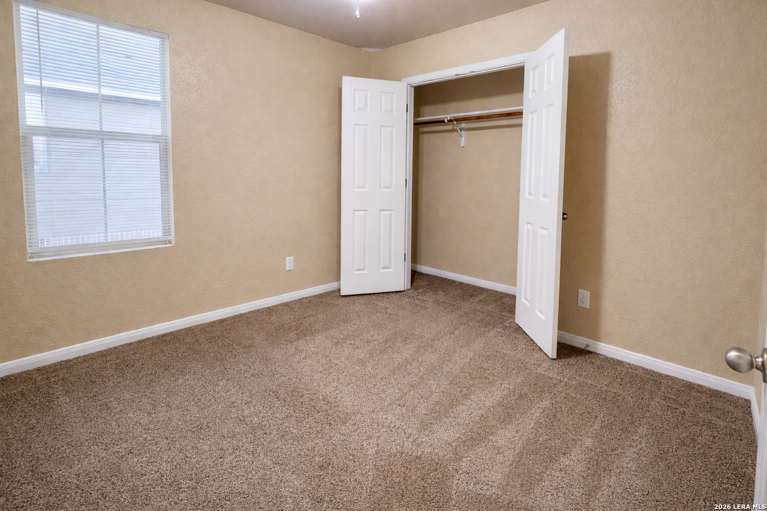 8711 8th Street, Unit 1 Converse, TX 78109 - Photo 17 of 25 an empty room with closet and windows