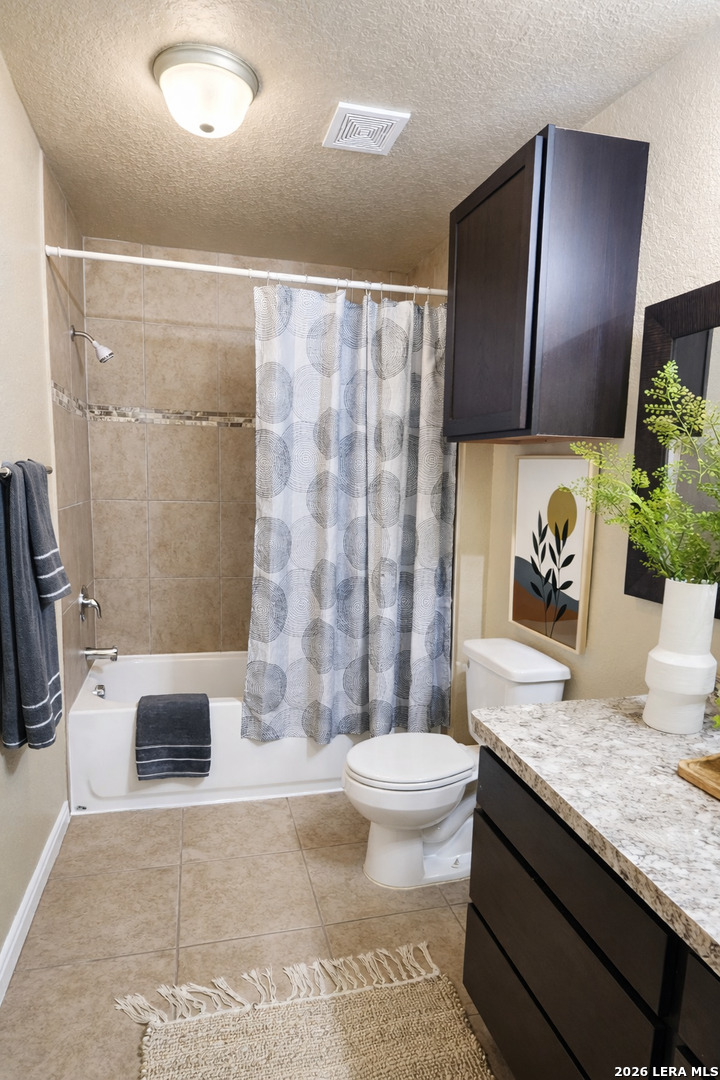 8711 8th Street, Unit 1 Converse, TX 78109 - Photo 21 of 25 a spacious bathroom with a granite countertop sink a toilet a mirror and shower