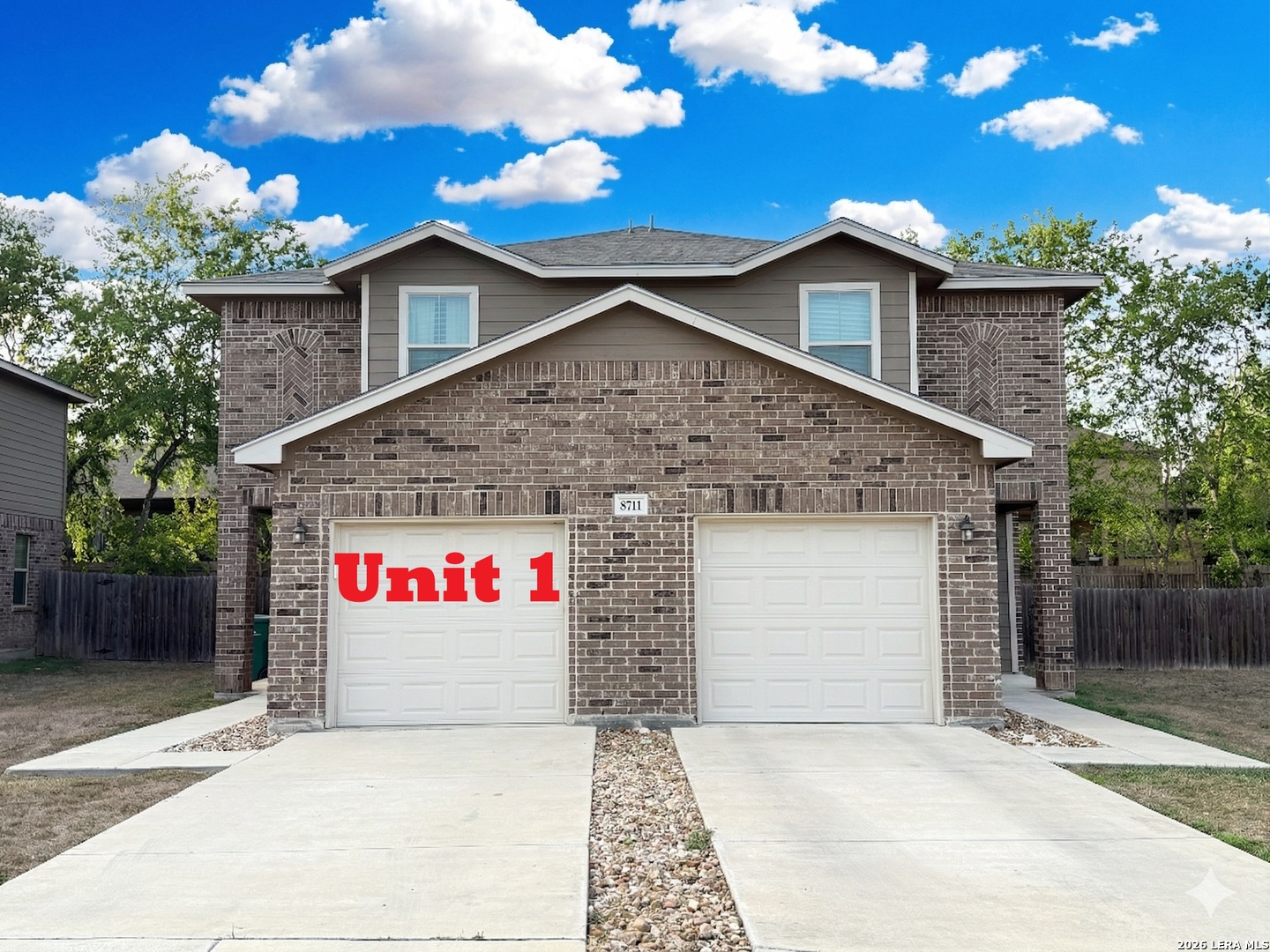 8711 8th Street, Unit 1 Converse, TX 78109 - Photo 24 of 25 a front view of a house with a garage