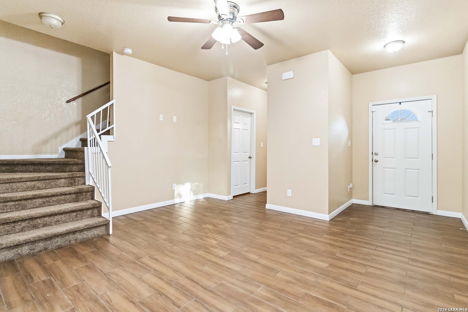 8711 8th Street, Unit 1 Converse, TX 78109 - Photo 3 of 25 wooden floor in an empty room with a window