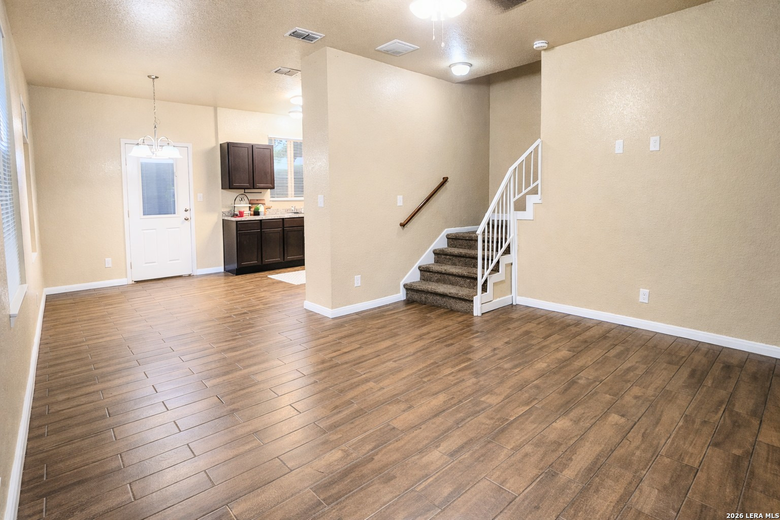 8711 8th Street, Unit 1 Converse, TX 78109 - Photo 4 of 25 a view of a kitchen with furniture and wooden floor