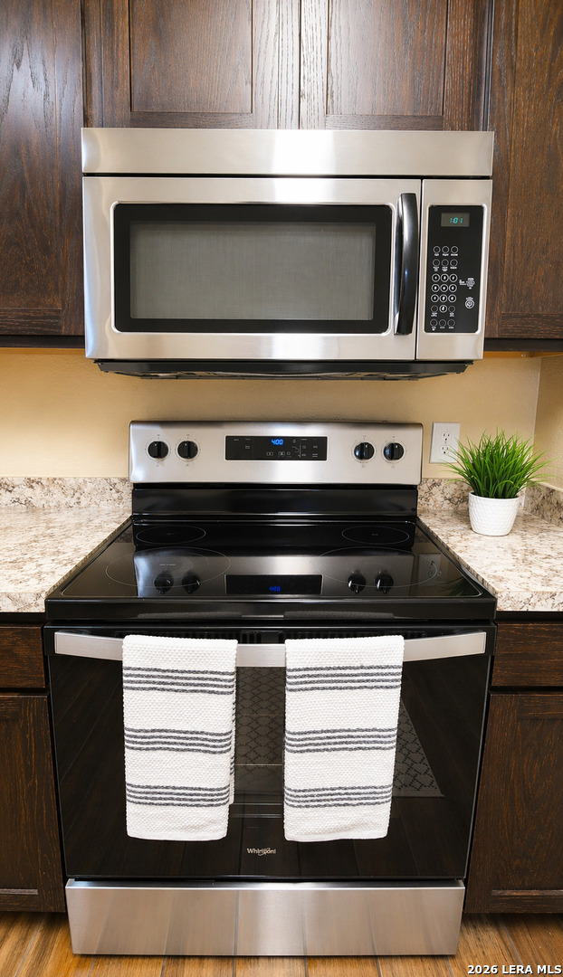 8711 8th Street, Unit 1 Converse, TX 78109 - Photo 7 of 25 a kitchen with a stove and a microwave