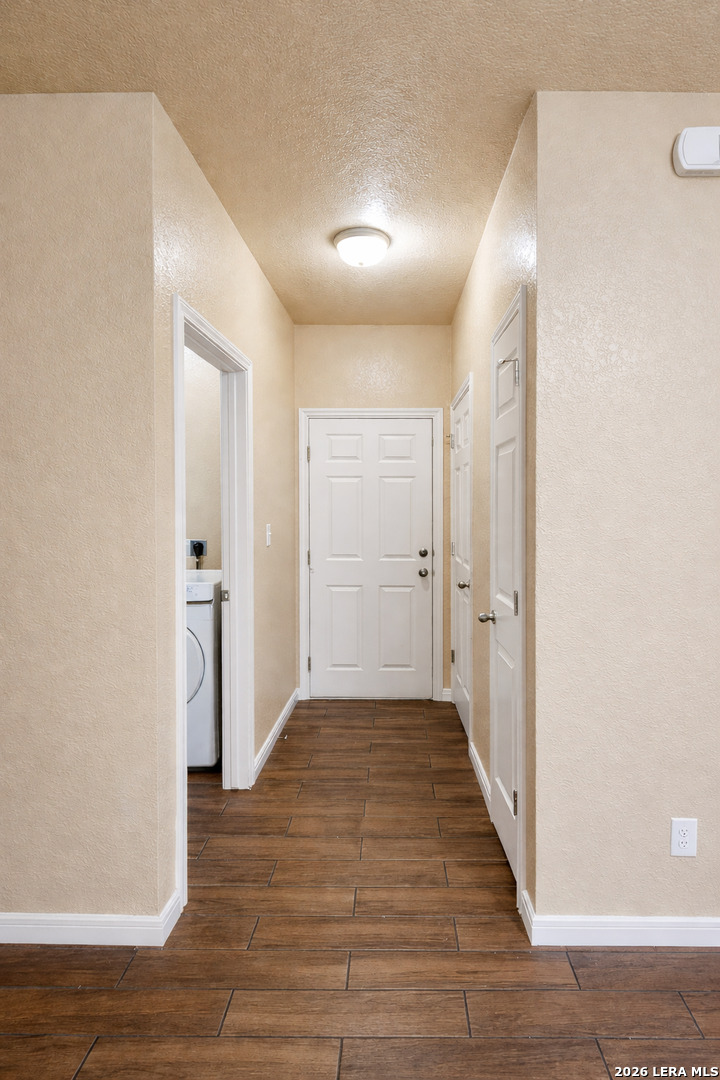 8711 8th Street, Unit 1 Converse, TX 78109 - Photo 9 of 25 a view of a hallway with wooden floor
