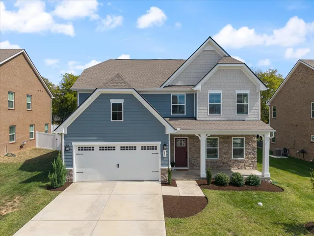 a front view of a house with a yard and garage