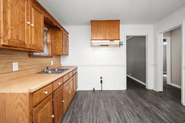 a kitchen with a sink and a refrigerator