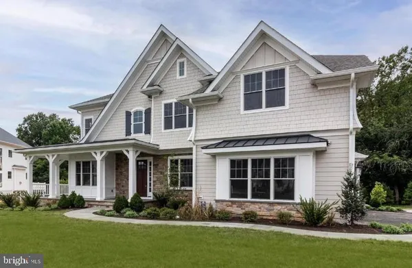 a front view of a house with a yard and porch