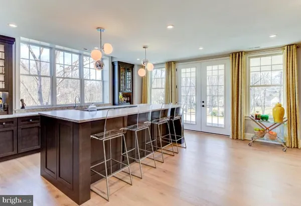 a room with lots of wooden furniture and windows