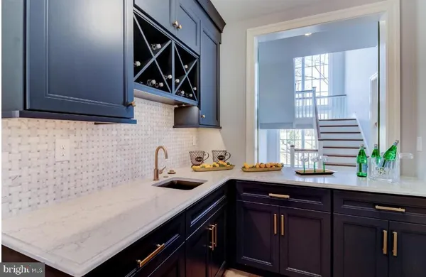 a kitchen with a sink a counter space cabinets and appliances