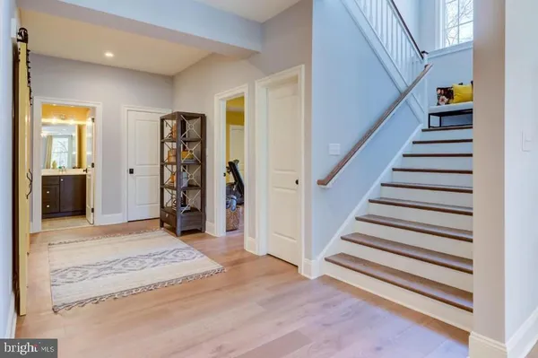 a view of a bedroom with wooden floor and stairs
