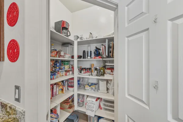 a very nice looking dining room with a computer on a table and chairs