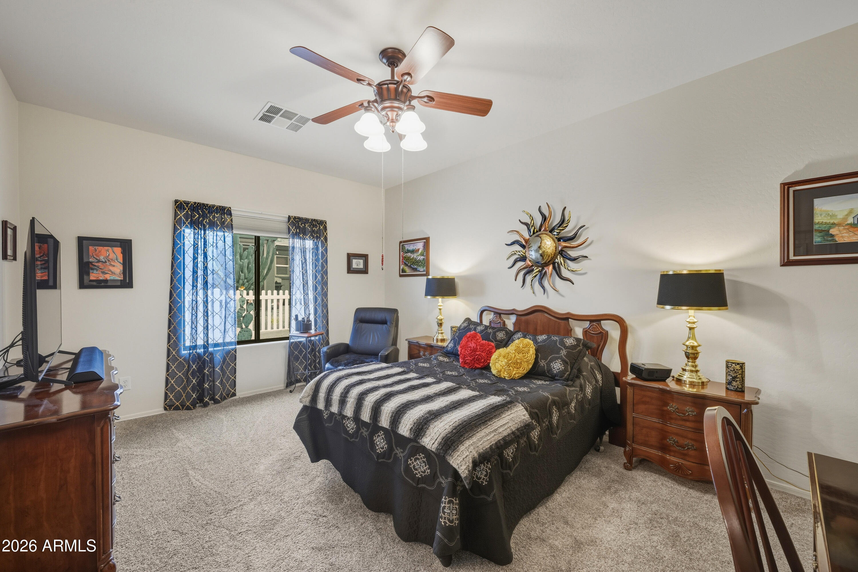 2101 South Meridian Road, Unit 198 Apache Junction, AZ 85120 - Photo 13 of 29 a bedroom with a bed and a chandelier