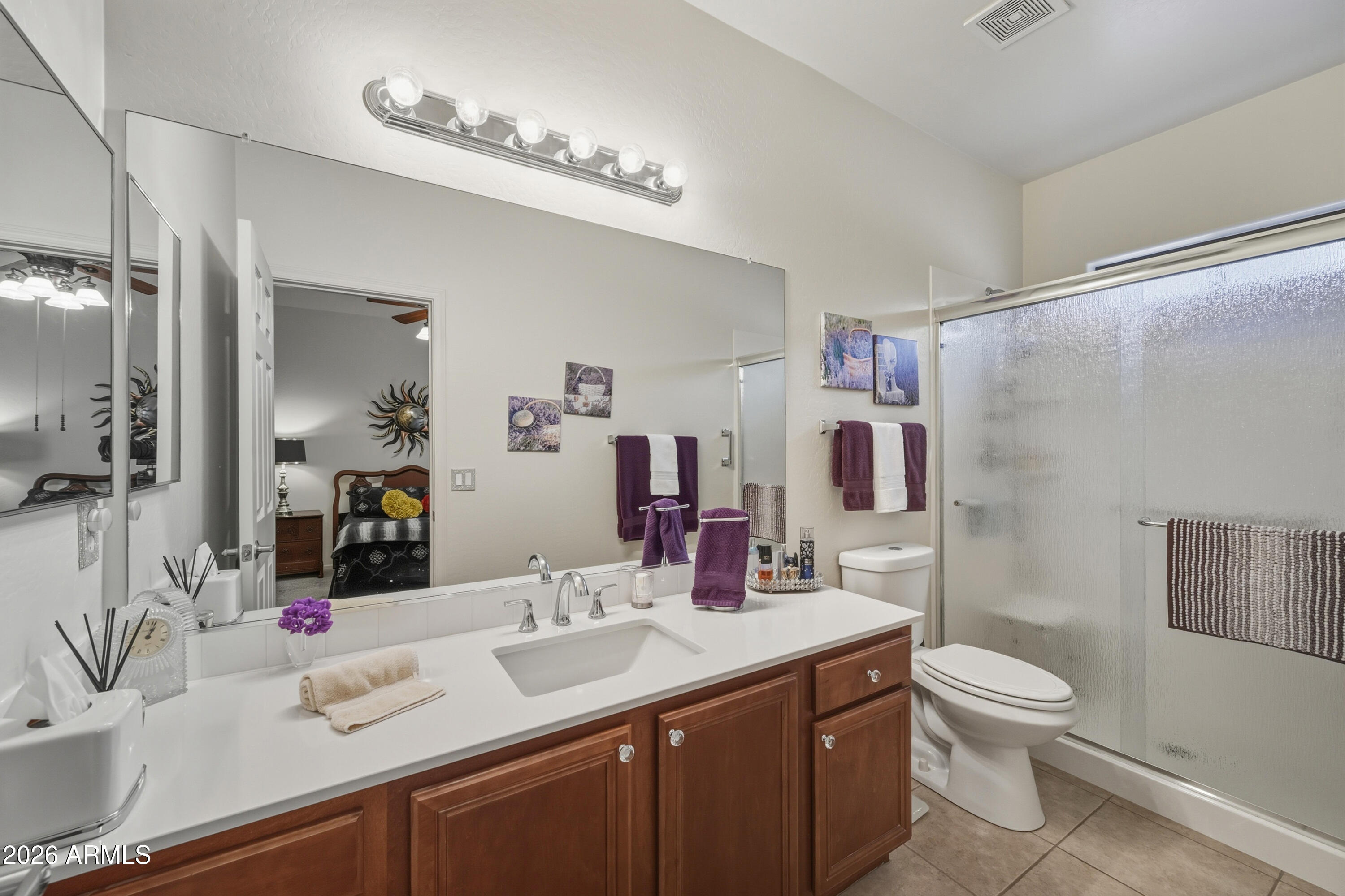 2101 South Meridian Road, Unit 198 Apache Junction, AZ 85120 - Photo 16 of 29 a bathroom with a granite countertop sink a toilet a mirror and shower