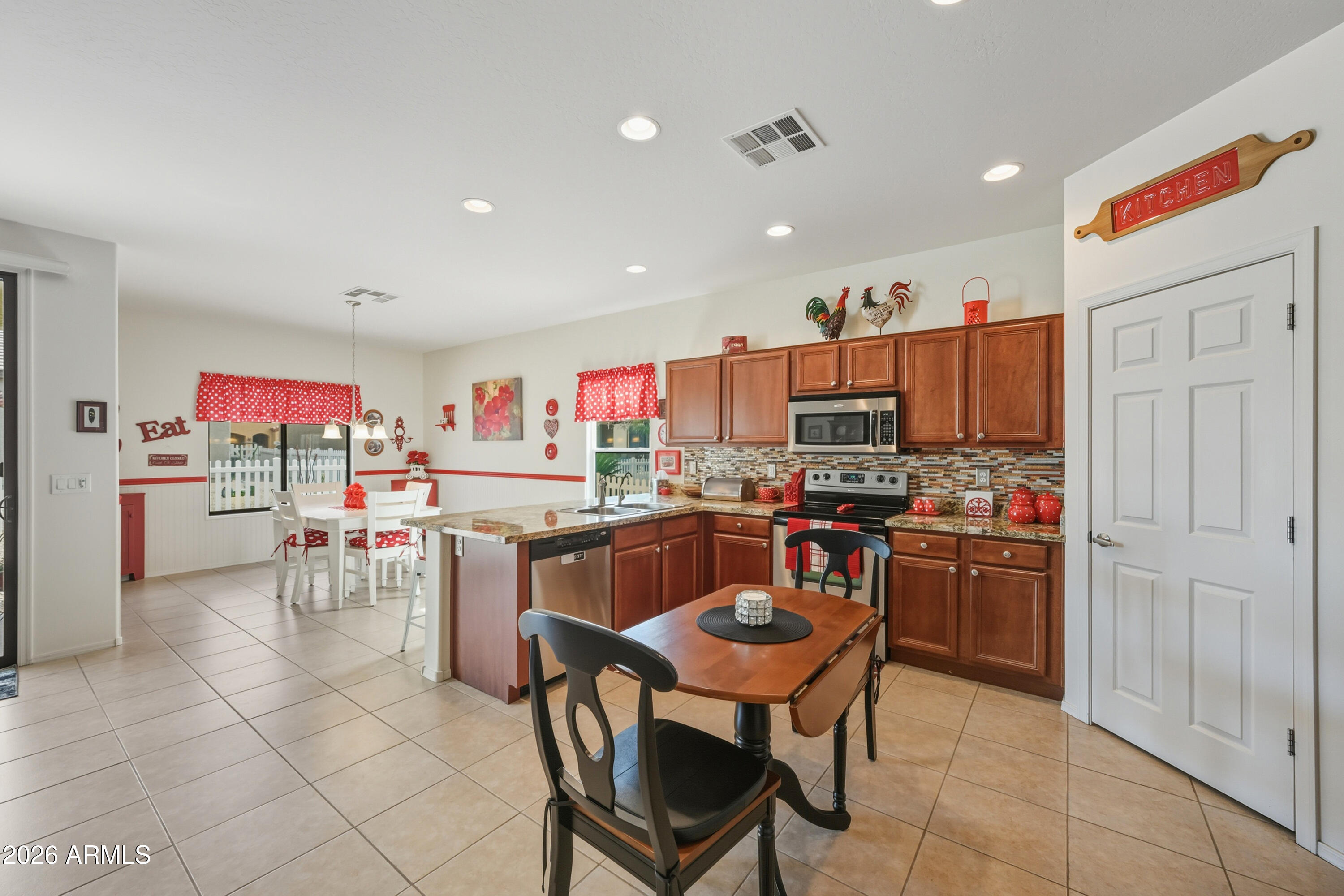 2101 South Meridian Road, Unit 198 Apache Junction, AZ 85120 - Photo 8 of 29 a kitchen with kitchen island granite countertop wooden cabinets and stainless steel appliances