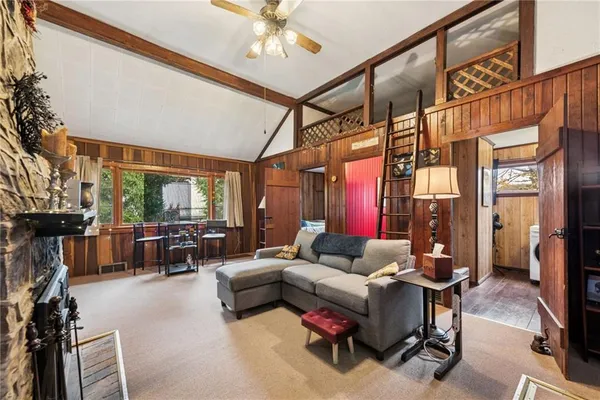 a living room with furniture and a floor to ceiling window