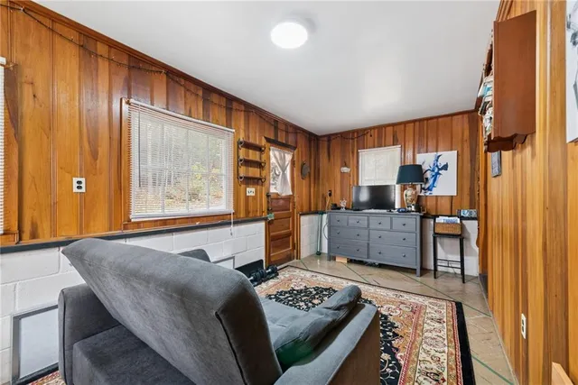 a bedroom with a bed and dresser with mirror