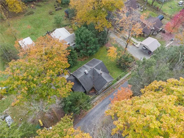 a aerial view of a house with a yard and lake view