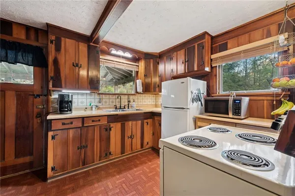 a kitchen that has a sink and a stove