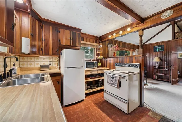 a kitchen with a stove and a refrigerator