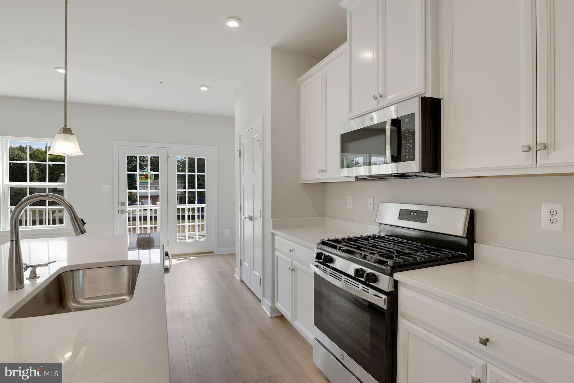 221 Edwin Road Frederick, MD 21702 - Photo 11 of 36 a kitchen with stainless steel appliances granite countertop a sink stove and microwave