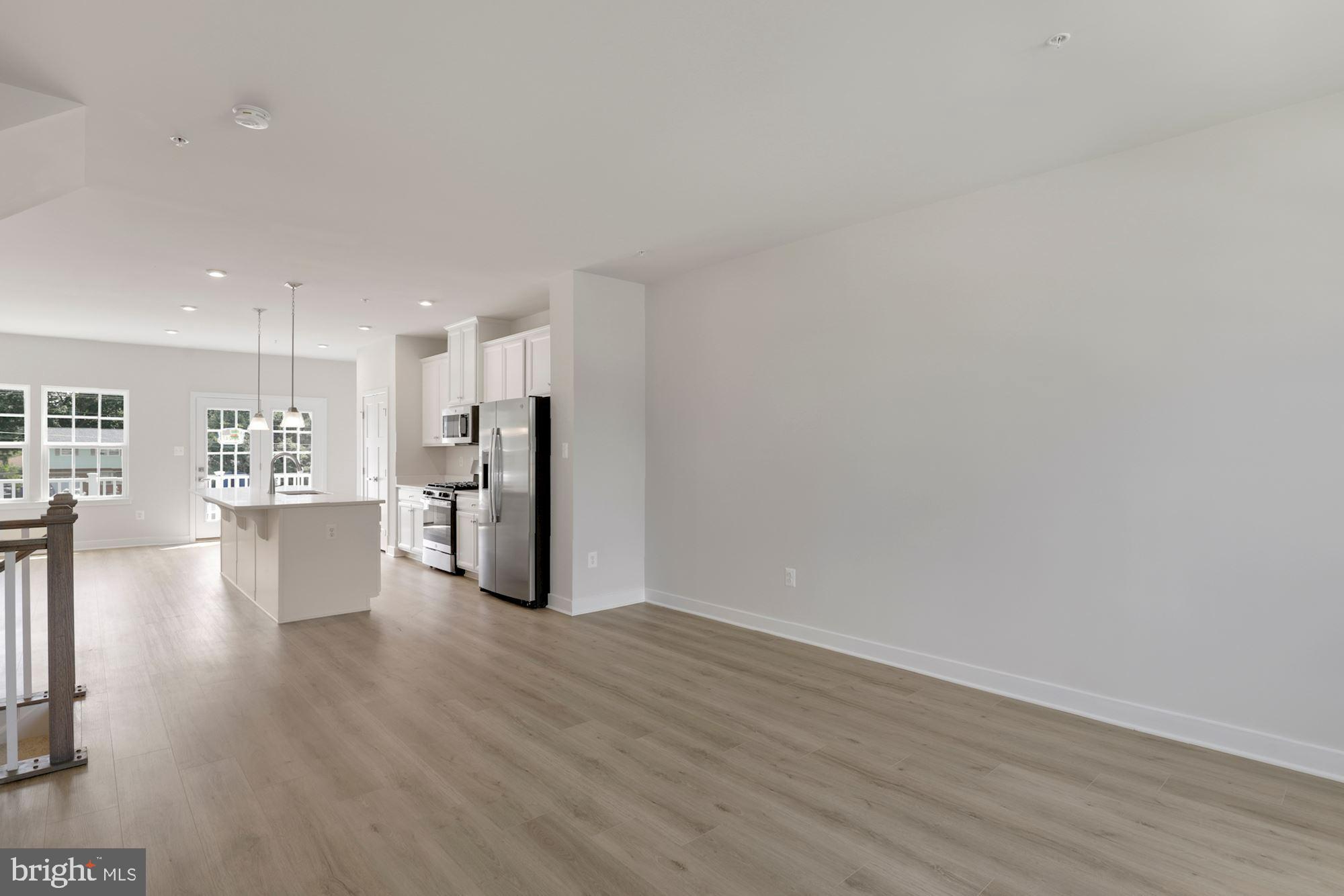 221 Edwin Road Frederick, MD 21702 - Photo 4 of 36 a view of a kitchen with a refrigerator and wooden floor