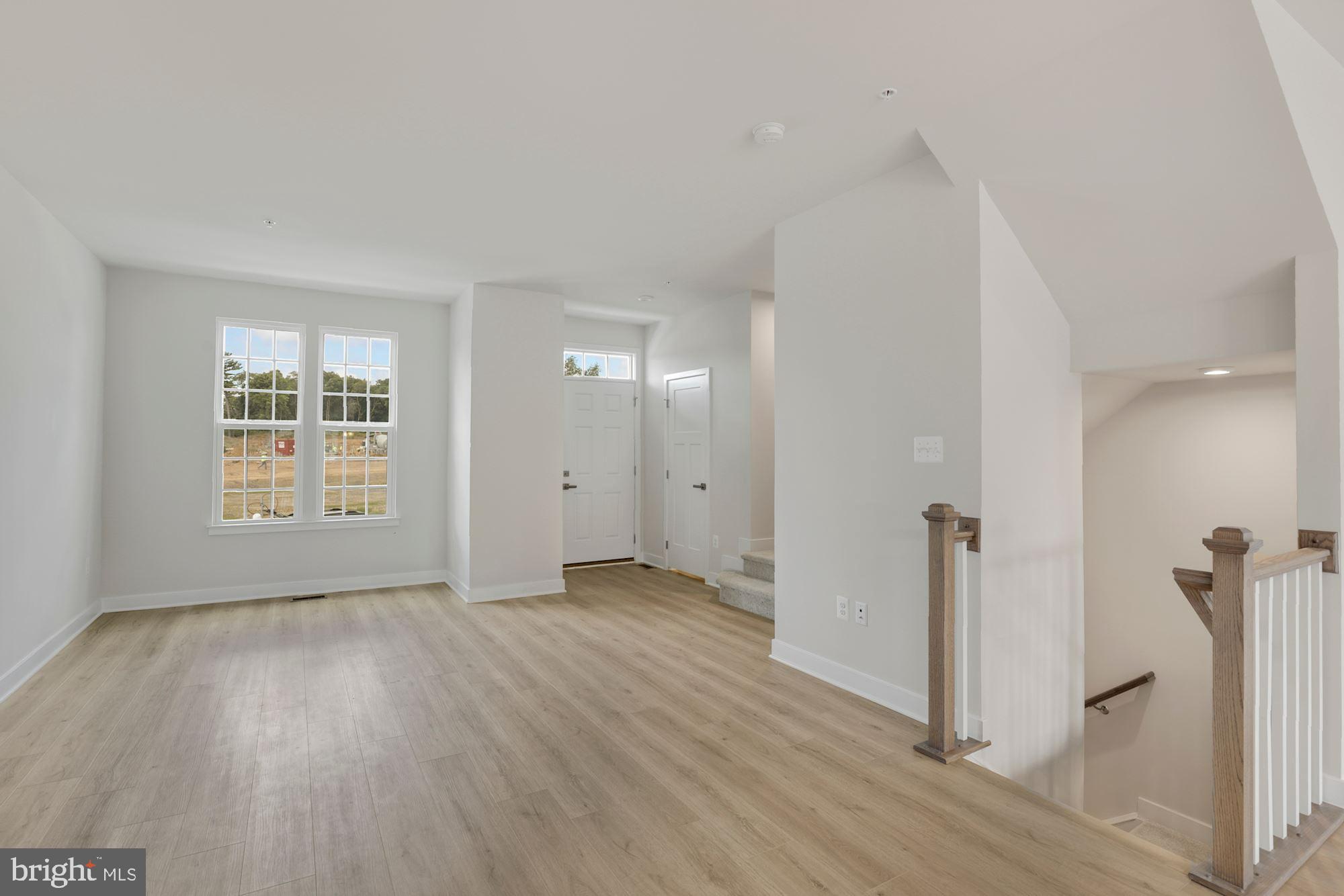 221 Edwin Road Frederick, MD 21702 - Photo 6 of 36 a view of an empty room with wooden floor and a window