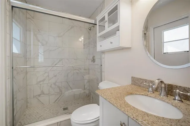 a large kitchen with stainless steel appliances a refrigerator and a stove top oven