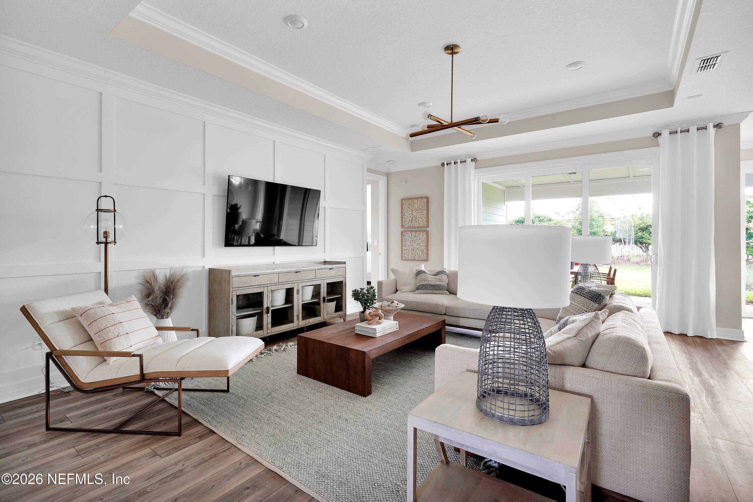 788 Del Webb Parkway Yulee, FL 32097 - Photo 6 of 38 a living room with furniture a flat screen tv and a window