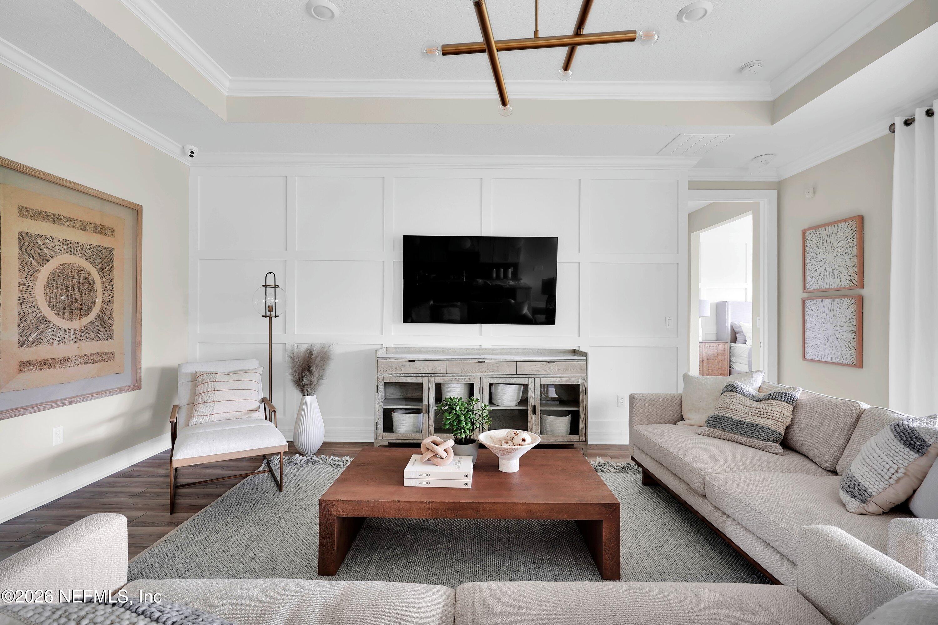 788 Del Webb Parkway Yulee, FL 32097 - Photo 7 of 38 a living room with furniture and a flat screen tv