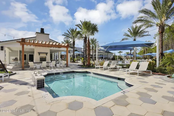 a view of a patio with swimming pool table and chairs