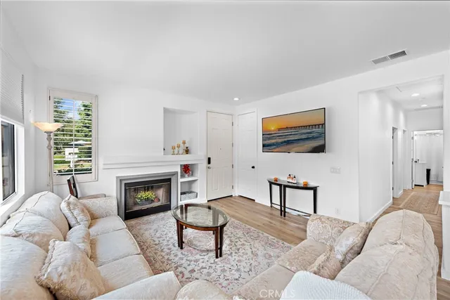 a living room with furniture flat screen tv and a fireplace