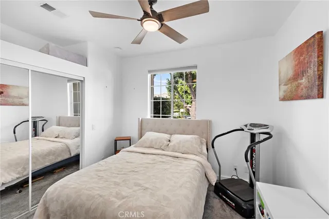 a bedroom with bed and a window