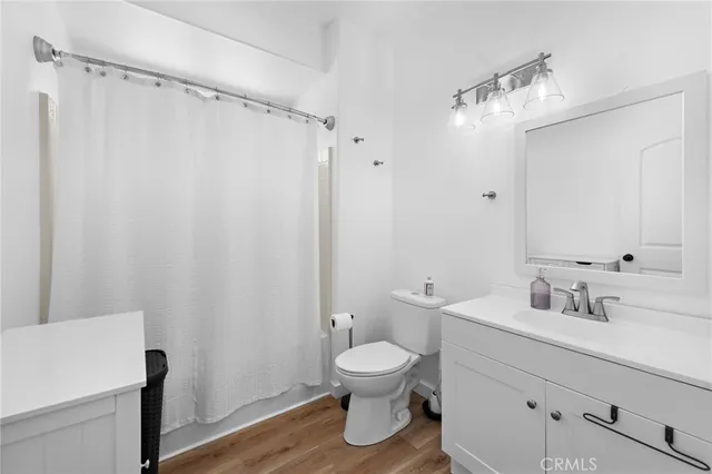 a bathroom with a toilet a sink and a mirror