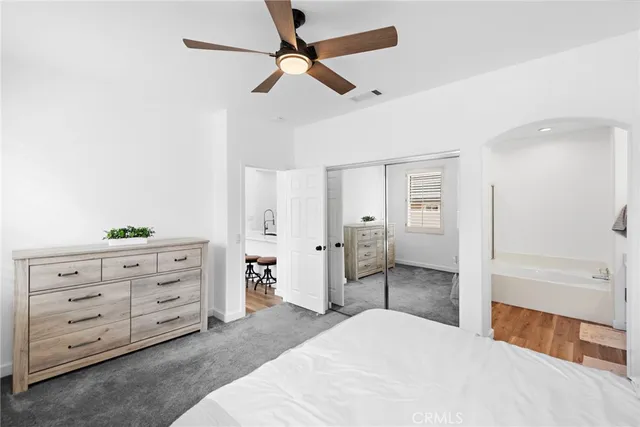 a bedroom with a bed and a dresser