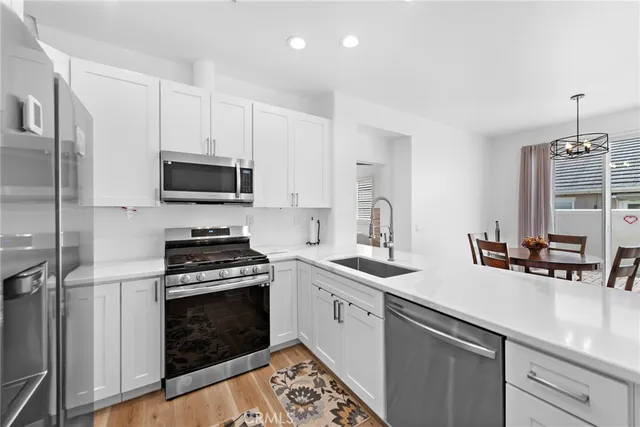 a kitchen with a sink stove and microwave