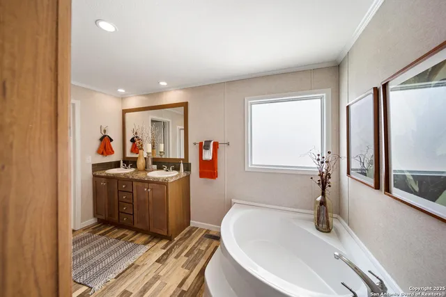 a kitchen with stainless steel appliances granite countertop a sink and a refrigerator