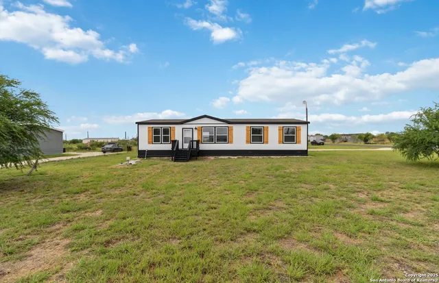 a view of a house with a big yard