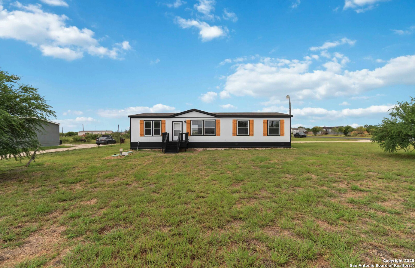1700 Sandbranch Road Bigfoot, TX 78005 - Photo 2 of 14 a view of a house with a big yard