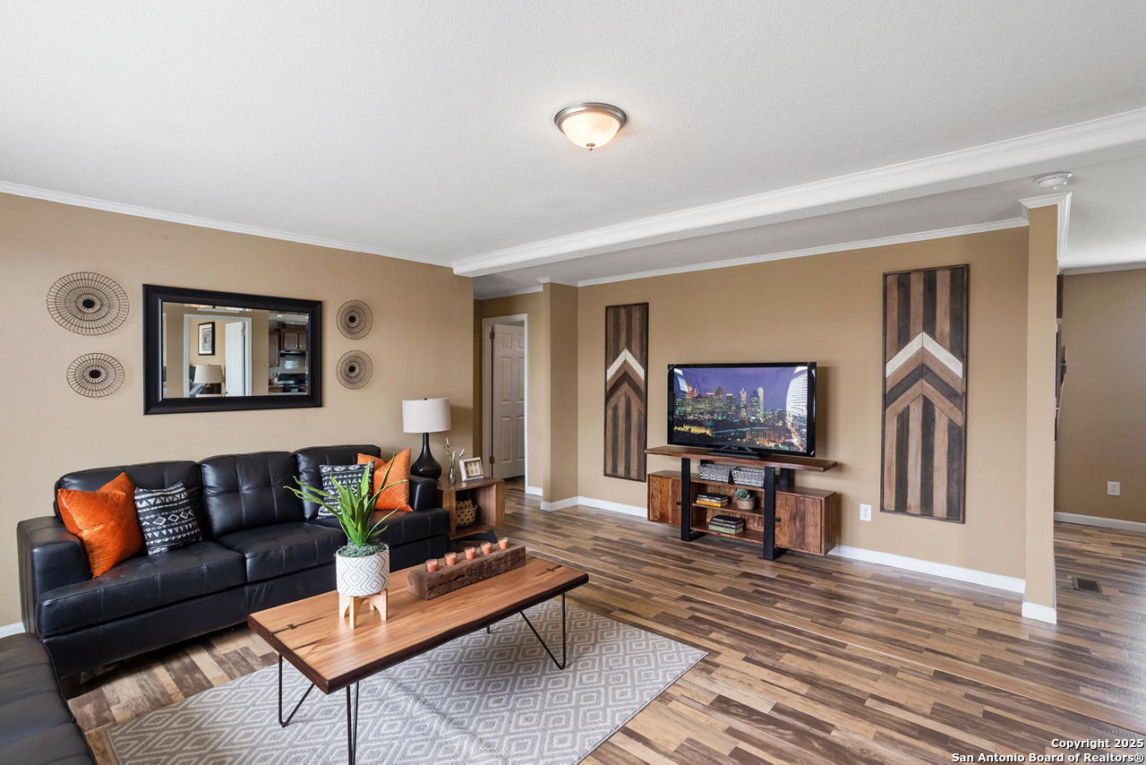 1700 Sandbranch Road Bigfoot, TX 78005 - Photo 3 of 14 a living room with furniture and a flat screen tv