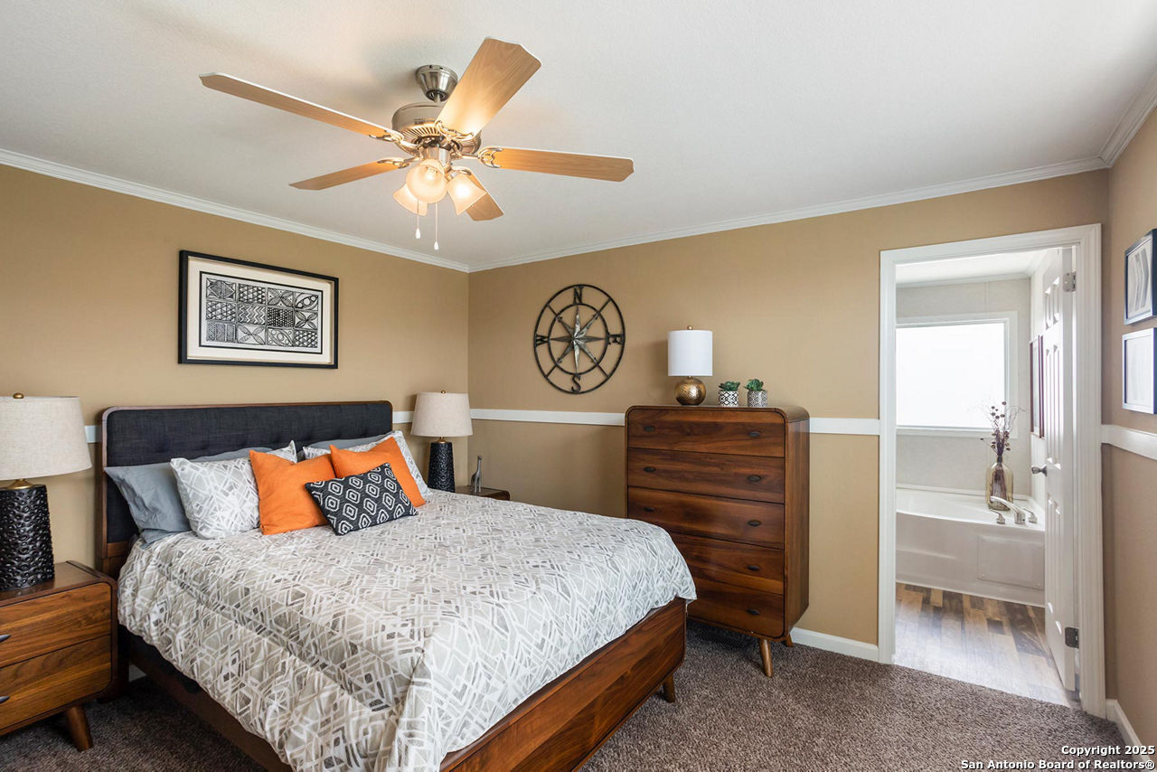 1700 Sandbranch Road Bigfoot, TX 78005 - Photo 8 of 14 a bedroom with a bed and a chandelier