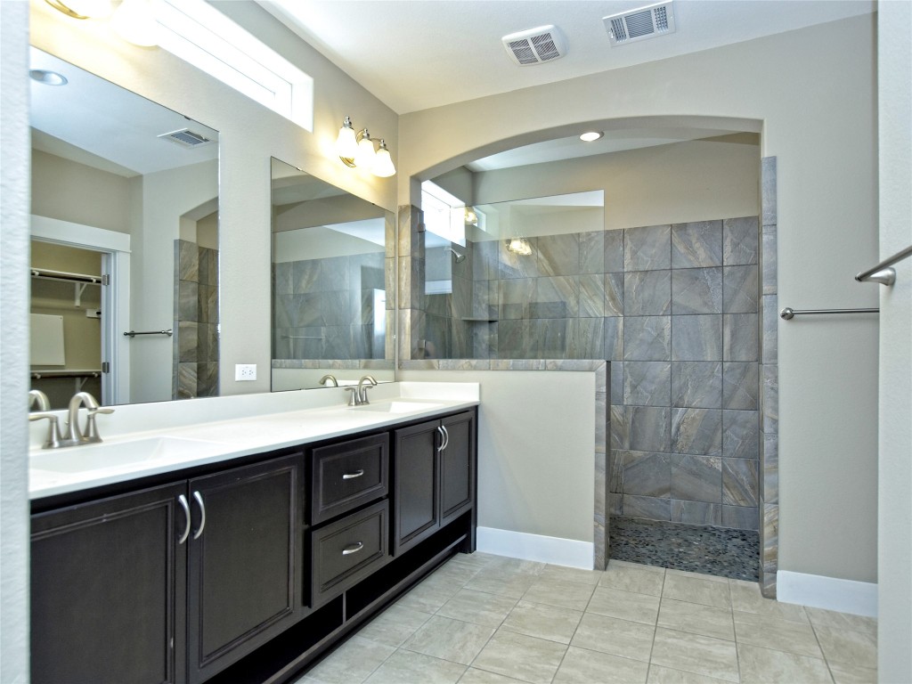 721 Clear Stream Crossing Austin, TX 78753 - Photo 13 of 24 a bathroom with a double vanity sink mirror and shower